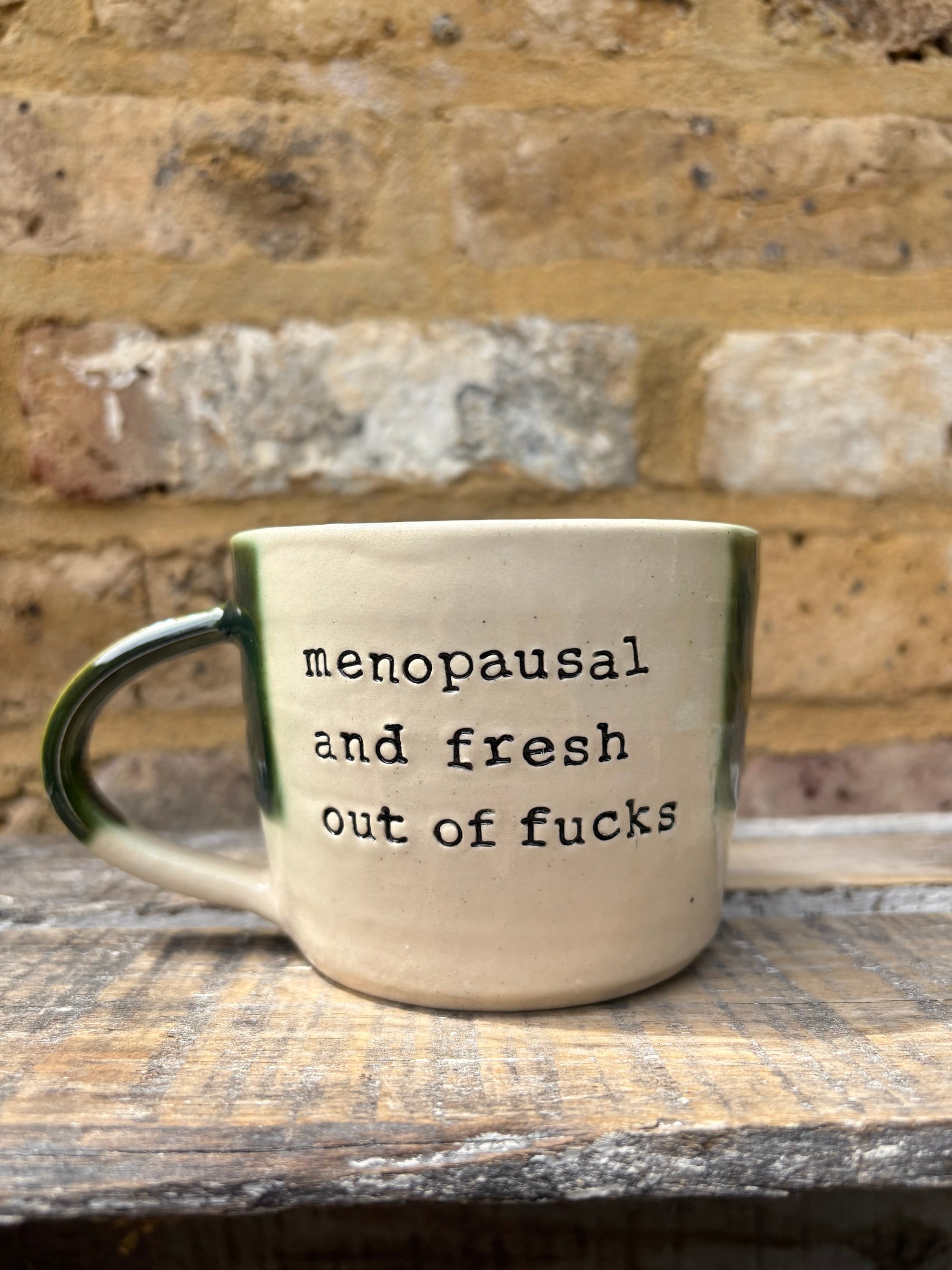 "menopausal and fresh out of fucks" mug (green)