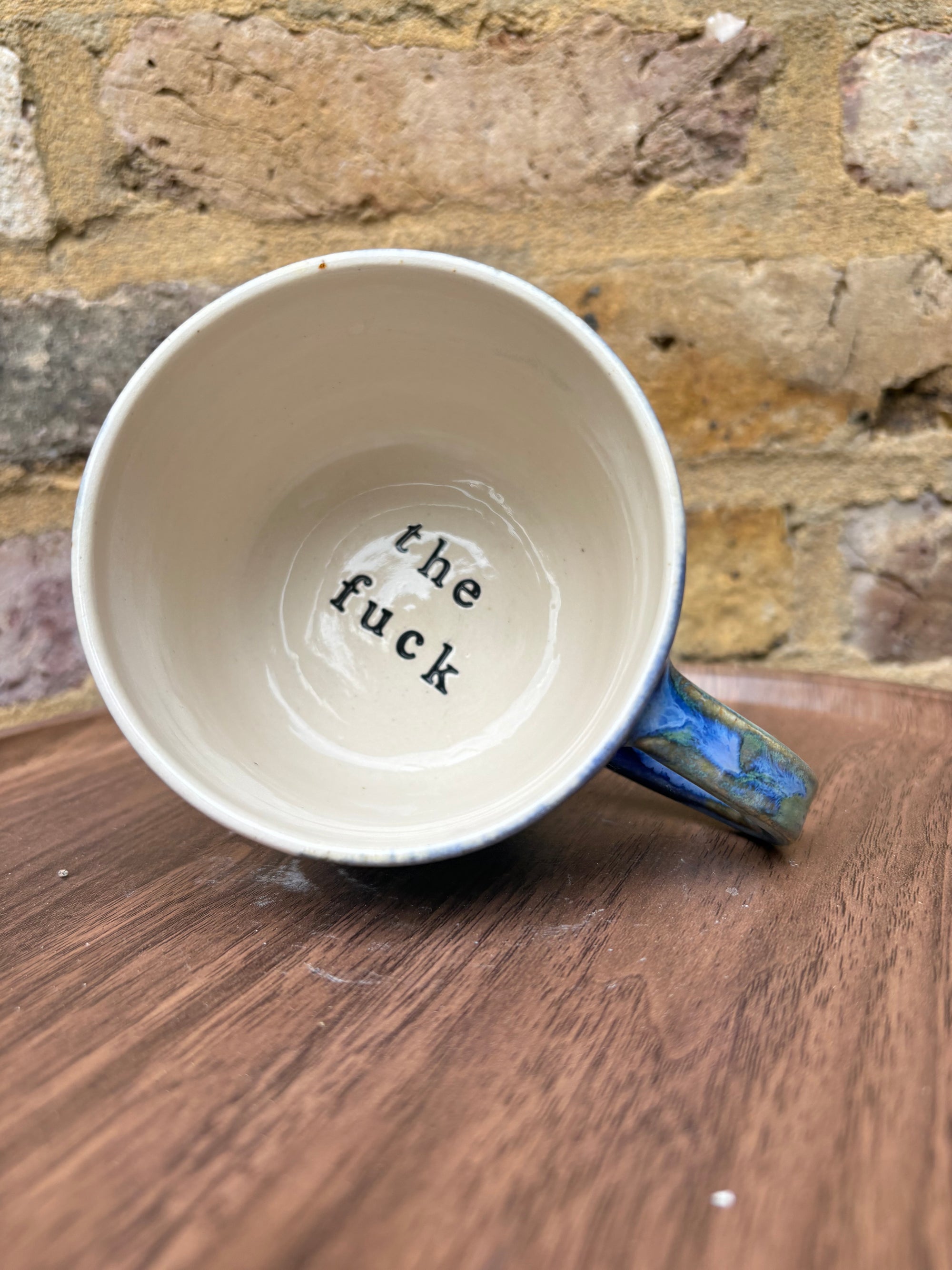 “What” “the fuck” mug (cream, blue/green)