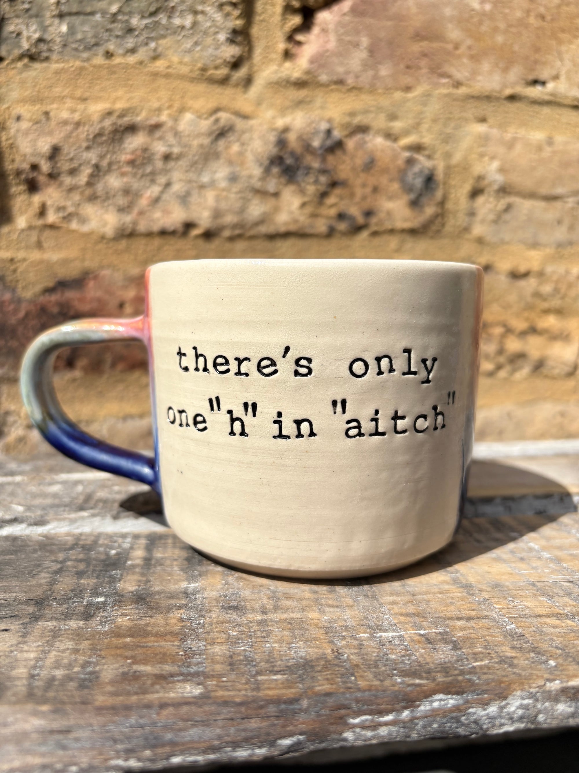 ""there's only one "h" in "aitch" mug (pink night sky)