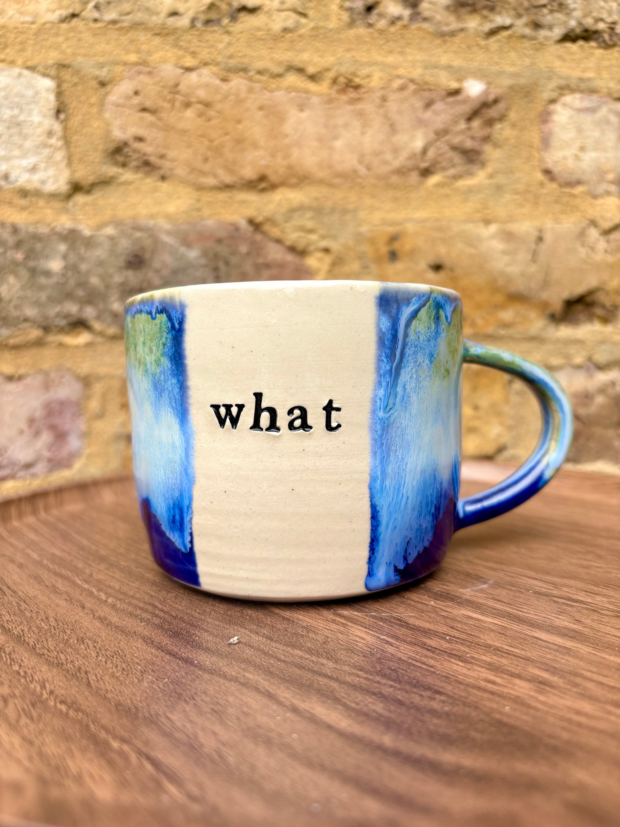 “What” “the fuck” mug (cream, blue/green)