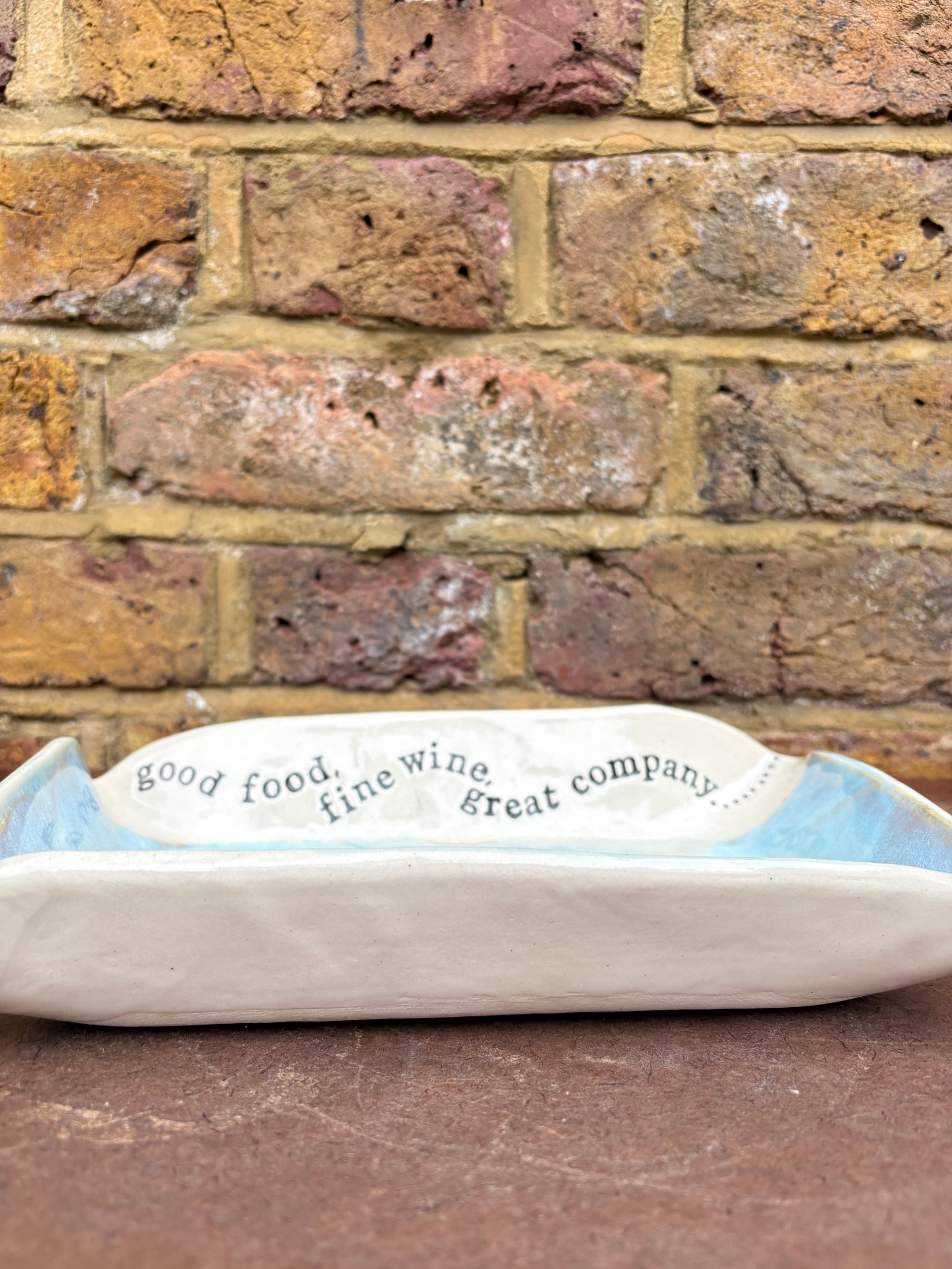 “good food, fine wine, great company..." rectangular salad/serving dish