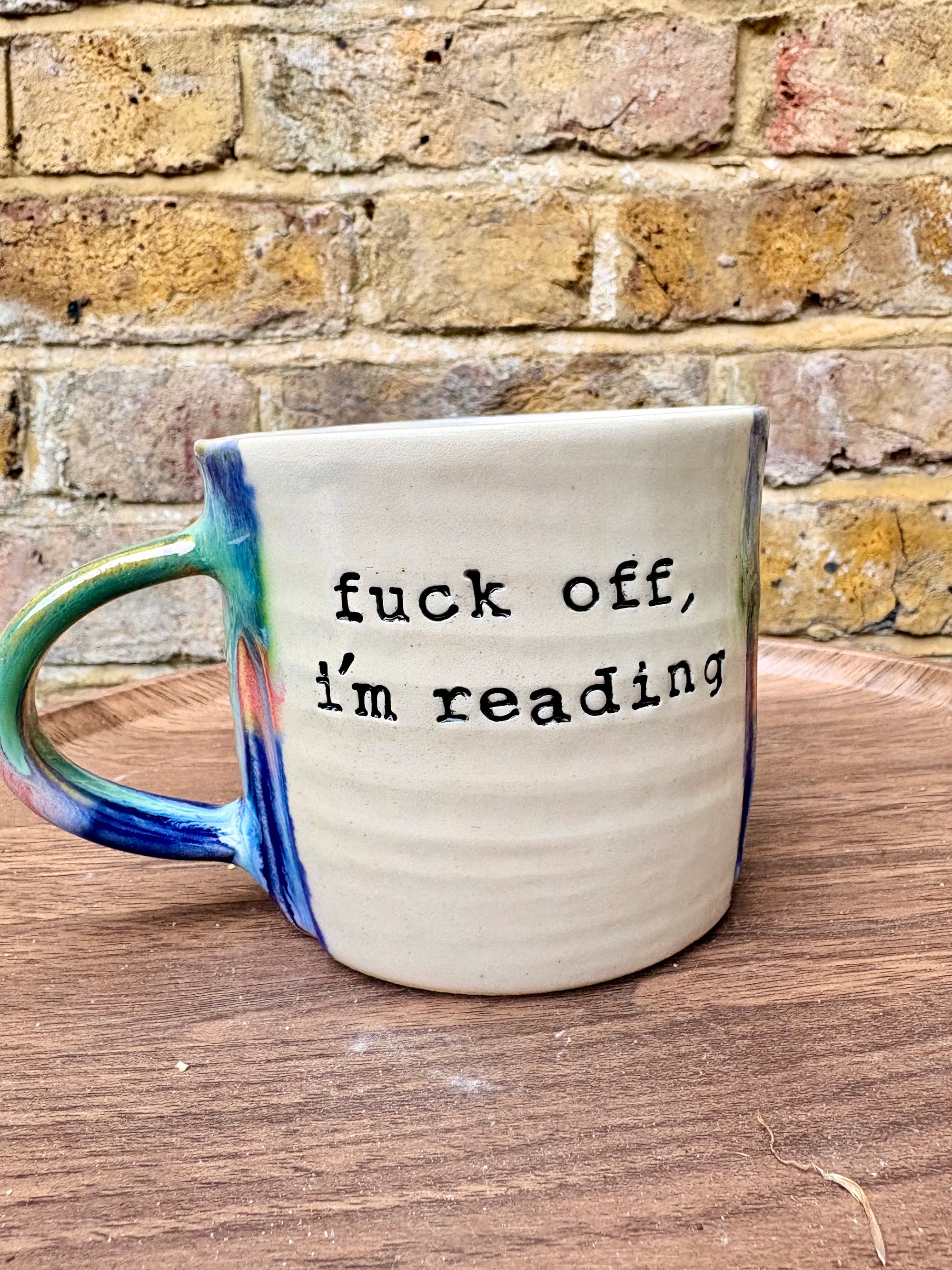 “Fuck off I’m reading" mug (greens/blues)
