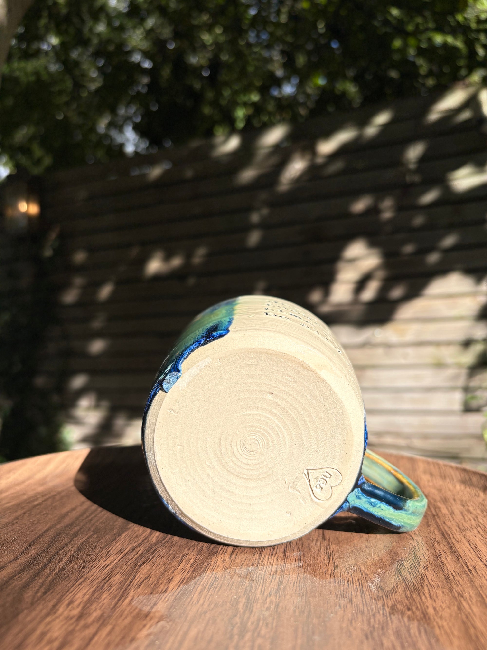 "what a fucked up time to be alive" mug (green/blue)